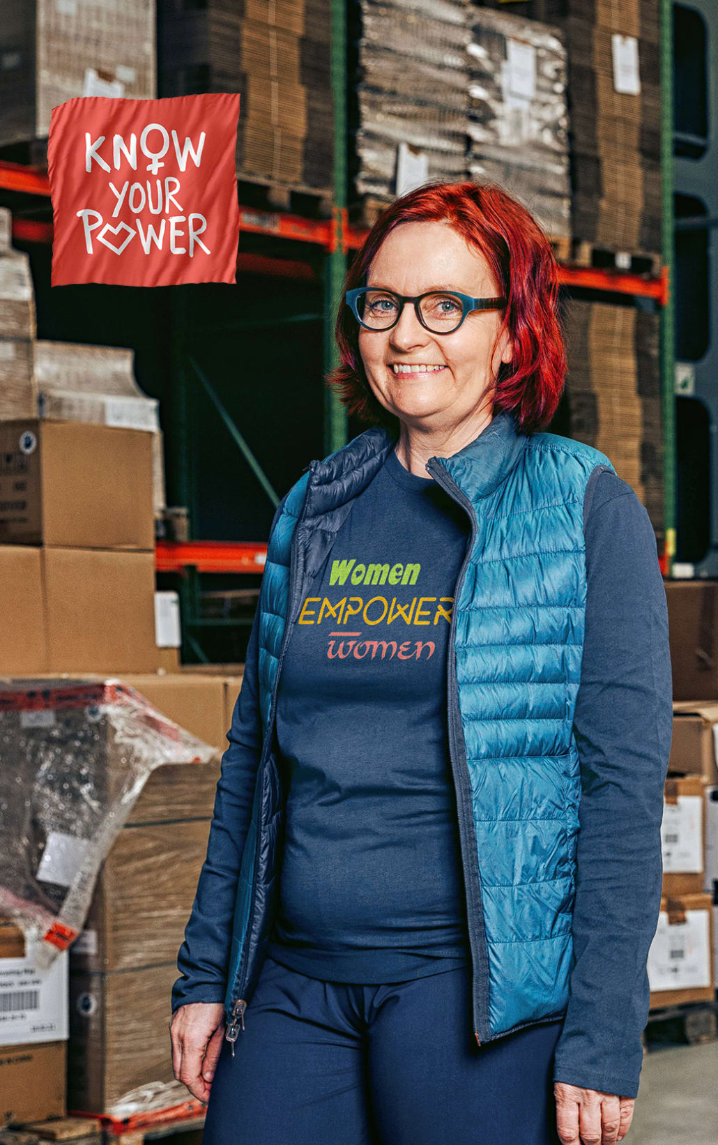 hanne in a delivery warehouse wears a long-sleeved t-shirt with a motif: women empower woman
